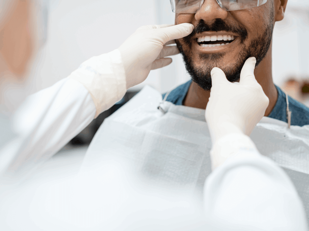 Man smiling as his smile is examined after a teeth whitening
