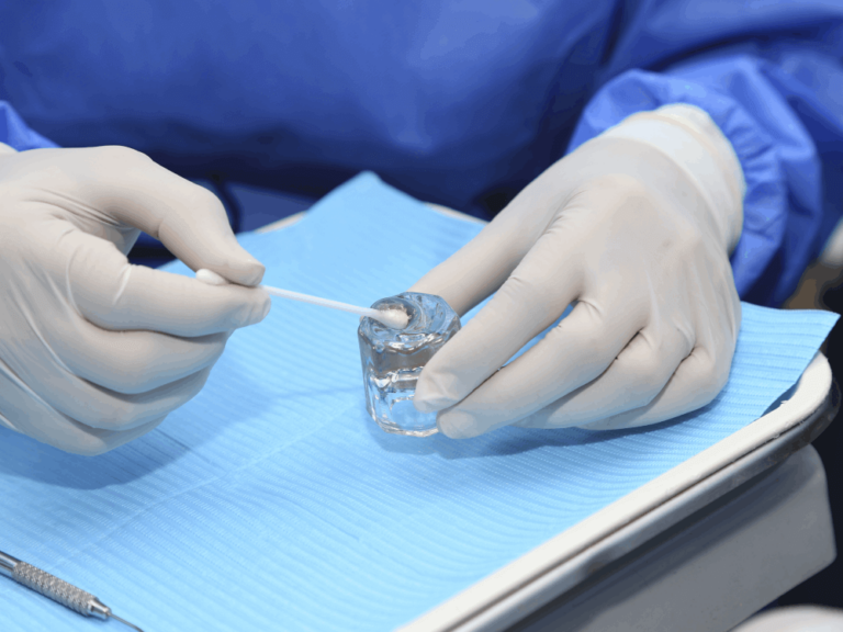 Dentist preparing to apply fluoride after teeth whitening